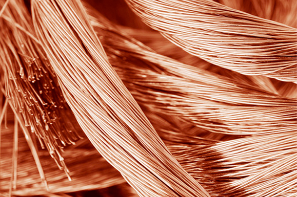 Dynamic Metal Recycling | Close-up of intertwined copper wires, showcasing the detailed texture and fine strands of the metal, emphasizing their role in electronics recycling. Dynamic Metal Recycling | Close-up of intertwined copper wires, showcasing the detailed texture and fine strands of the metal, emphasizing their role in electronics recycling.